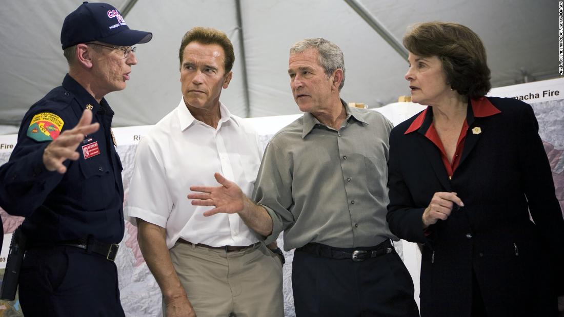 A fire official briefs California Gov. Arnold Schwarzenegger, President George W. Bush and Feinstein at Kit Carson Park after touring a neighborhood of destroyed homes in the Rancho Bernardo area of San Diego in 2007.