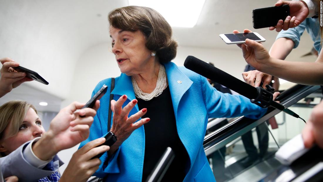 Reporters surround Feinstein as she arrives on Capitol Hill for a vote in 2018.