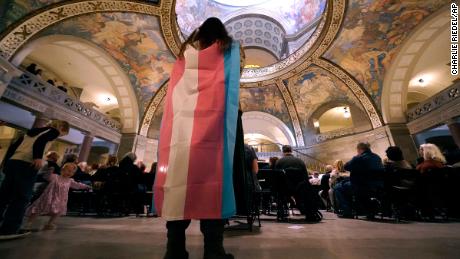 Glenda Starke wears a transgender flag as a counterprotest during a rally in favor of a ban on gender-affirming health care legislation on March 20, at the Missouri Statehouse in Jefferson City, Missouri.