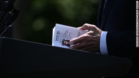 President Joe Biden looks at a note card referencing a reporter and a question during a news conference in the Rose Garden on April 26, 2023. 