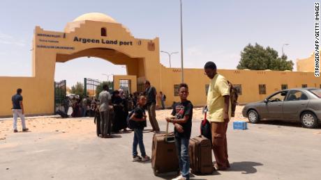 People cross into Egypt from Sudan on April 27, 2023. Several Sudanese citizens told CNN they cannot flee the conflict-ridden country because their passports are held at evacuated Western embassies.