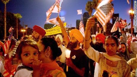 Sikhs in Los Angeles wave American flags during a memorial for the 9/11 victims. Several Sikhs were targeted in the days after the attacks as some wrongly associated their turbans with terrorists. 
