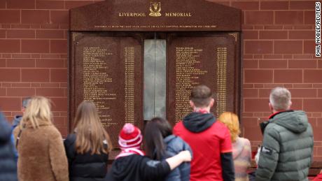 Fans look at the memorial in memory of the victims of the Hillsborough disaster outside Anfield.