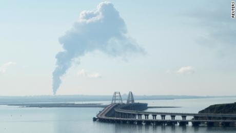 A view across the Kerch Strait shows smoke rising above a fuel depot near the Crimean bridge in the village of Volna in Russia&#39;s Krasnodar region, as seen from a coastline in Crimea, on May 3, 2023.