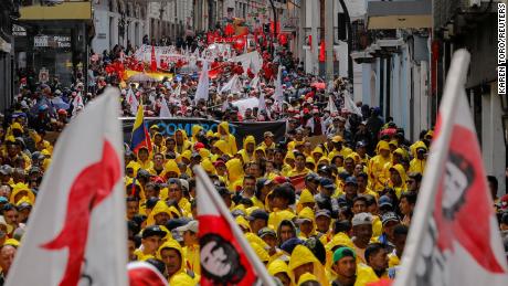Members of unions and civil society groups march on International Workers&#39; Day to demand that Ecuador&#39;s President Guillermo Lasso, who is facing an impeachment process, leave office on May 1, 2023. 