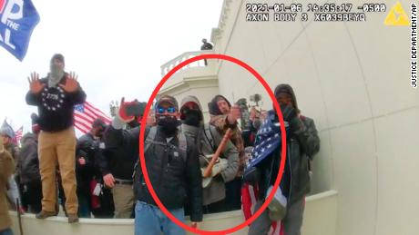 In this image from a Washington Metropolitan Police Department officer&#39;s body-worn video camera, released and annotated by the Justice Department in the Government&#39;s Sentencing Memorandum, Peter Schwartz circled in red is shown using a canister of pepper spray against officers on January 6, 2021, in Washington.