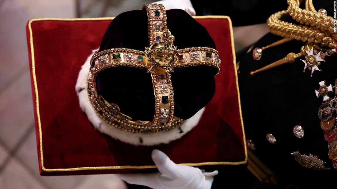 The St. Edward&#39;s Crown is carried inside Westminster Abbey.