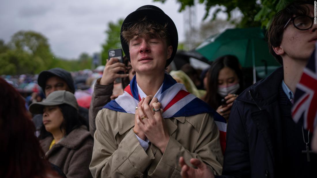 Royal fan Ben Weller reacts as he watches the coronation on a screen in London&#39;s Hyde Park.