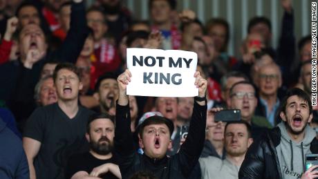 A Liverpool fan holds up a sign saying &#39;Not My King.&#39;
