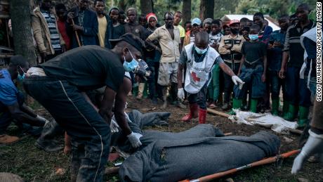  Congolese Red Cross volunteers and residents of Nyamukubi wrap in blankets the bodies of people who died in heavy flooding in eastern Democratic Republic of Congo, on May 6, 2023.