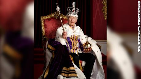In this photo made available by Buckingham Palace on Monday, May 8, 2023, Britain&#39;s King Charles III poses for a photo in full regalia in the Throne Room, London.