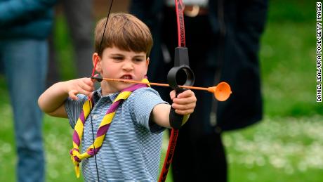 Prince Louis tries his hand at archery while taking part in the Big Help Out.