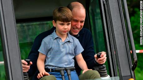 Prince Louis helped his father, the Prince of Wales, use an excavator while taking part in the Big Help Out, during a visit to the 3rd Upton Scouts Hut.