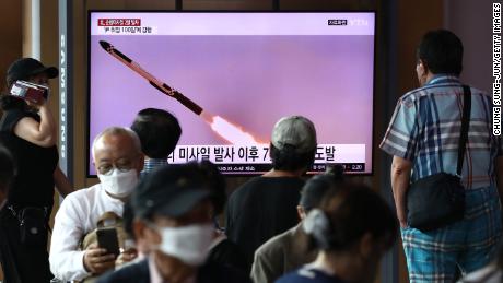 People watch a television screen showing a file image of a North Korean missile launch at the Seoul Railway Station on August 17, 2022 in Seoul, South Korea. 