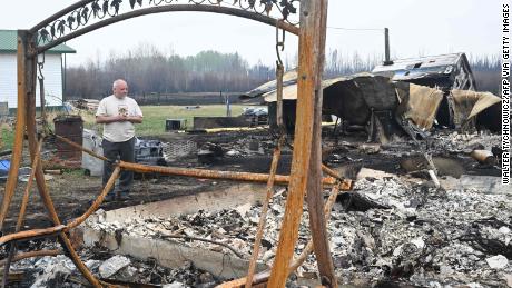 Property owner Adam Norris surveys the damage at his home in Drayton Valley, Alberta, Canada, on May 8, 2023.