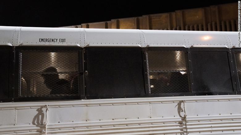 Migrants board a bus after surrendering to US Border Patrol agents in Yuma on May 11.