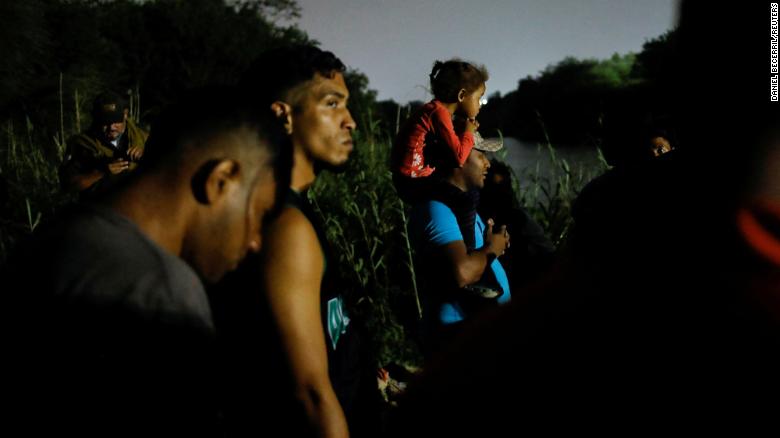 Migrants gather on the banks of the Rio Grande in Matamoros, Mexico, on May 11 as they get ready to cross the border to turn themselves in.