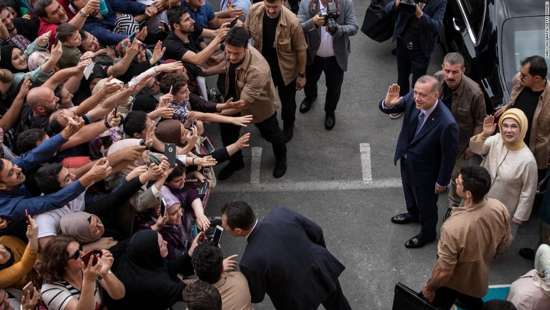 The Erdogans wave to supporters in Istanbul after voting in elections in June 2018. Erdogan won his second term as president.