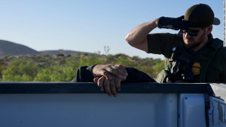 A US Border Patrol agent searches a man from Mexico who crossed the border illegally near Sunland Park on May 12.