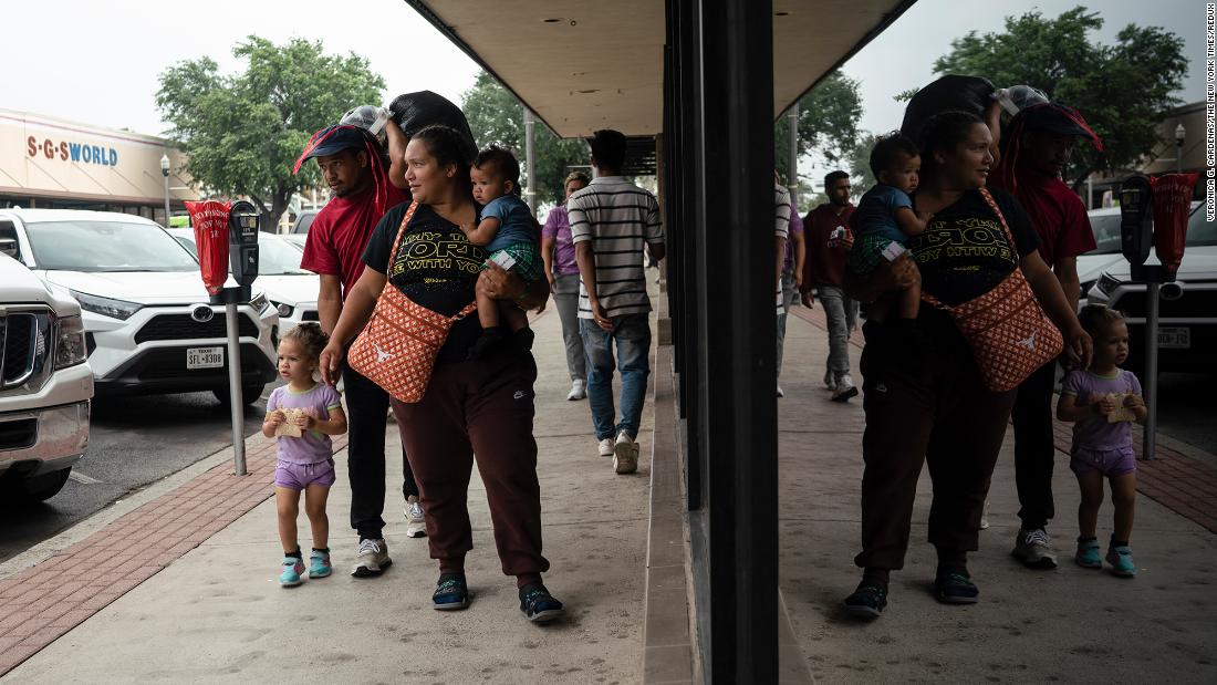 Ligia Garcia and her husband, Robert Castellon, walk with their children to buy food after they were processed by US border officials in McAllen, Texas, on May 12.