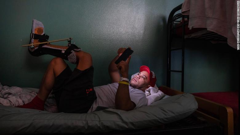 Merejido Del Orbe, who came to the United States from the Dominican Republic, rests at Annunciation House, a shelter in El Paso, Texas, on May 11. He broke his leg when he slipped from a rope while climbing a border fence in April.