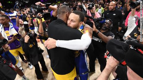 LeBron James and Stephen Curry (right) embrace after the game. 
