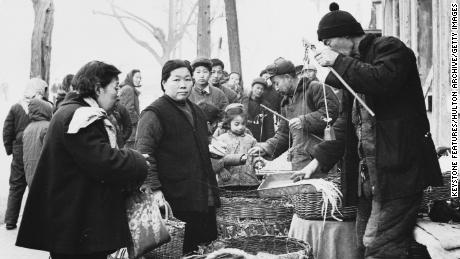 May 1959: Customers buying fresh vegetables from a market in China&#39;s capital. 