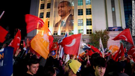 Erdogan supporters wave flags outside the Justice and Development (AK) Party headquarters in Ankara, Turkey, after the president performed better in the first round than pre-election polls suggested.