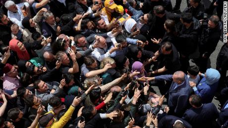 Turkish President Tayyip Erdogan and his wife Emine Erdogan meet supporters outside a polling station in Istanbul, Turkey May 14, 2023.