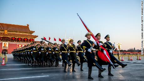 The Guard of Honor of the Chinese People&#39;s Liberation Army (PLA) escorts the national flag during a flag-raising ceremony at  Tiananmen Square on January 1, 2023.