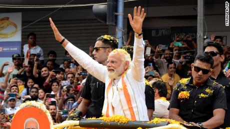 Indian Prime Minister Narendra Modi waves to the crowd during campaigning for state elections in Bengaluru, Karnataka, on May 7. 