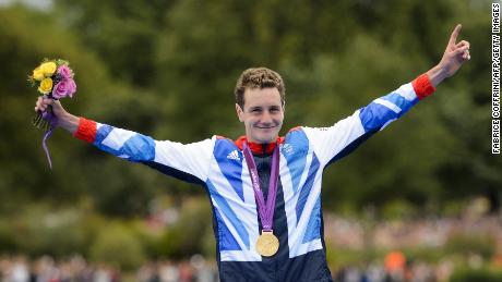 Alistair Brownlee celebrates on the podium after winning gold in the men&#39;s triathlon event at the London 2012 Olympic Games.