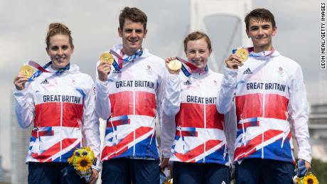 Jessica Learmonth, Jonathon Brownlee, Georgia Taylor-Brown and Alex Yee of Team Great Britain celebrate on the podium during the medal ceremony following the Mixed Relay Triathlon.
