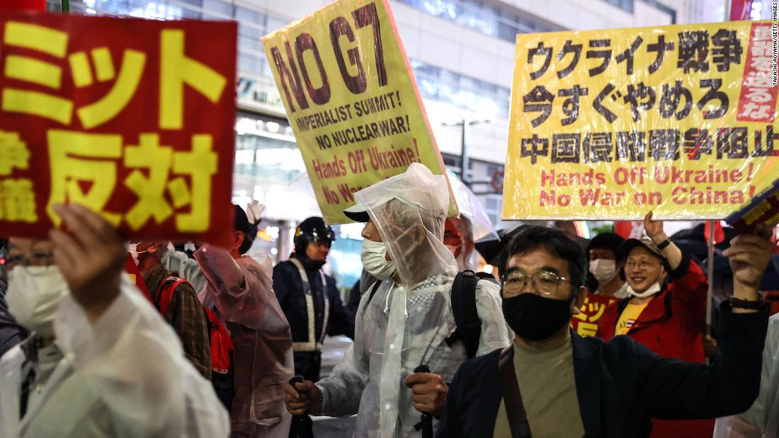 People hold signs and chant slogans during the march to protest against G7 Summit in Hiroshima on Thursday, May 18.