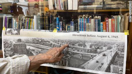 Terao points to a photograph showing Hiroshima before the atomic bombing and the house where he spent the first four years of his life. He said he grew up seeing the roof of what is now called the Genbaku Dome -- the only structure left standing in the area of the bombing -- every day from his childhood home.