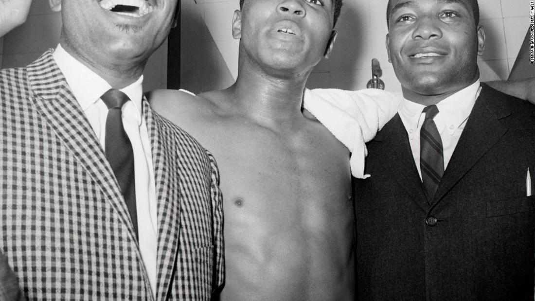 Brown, right, joins boxers Sugar Ray Robinson and Muhammad Ali after Ali won a bout in 1963.