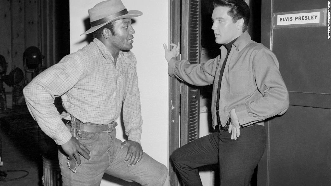 Brown visits with Elvis Presley as Presley was filming the 1964 film &quot;Roundabout.&quot; Brown was working on the Western movie &quot;Rio Conchos,&quot; which was his film acting debut.