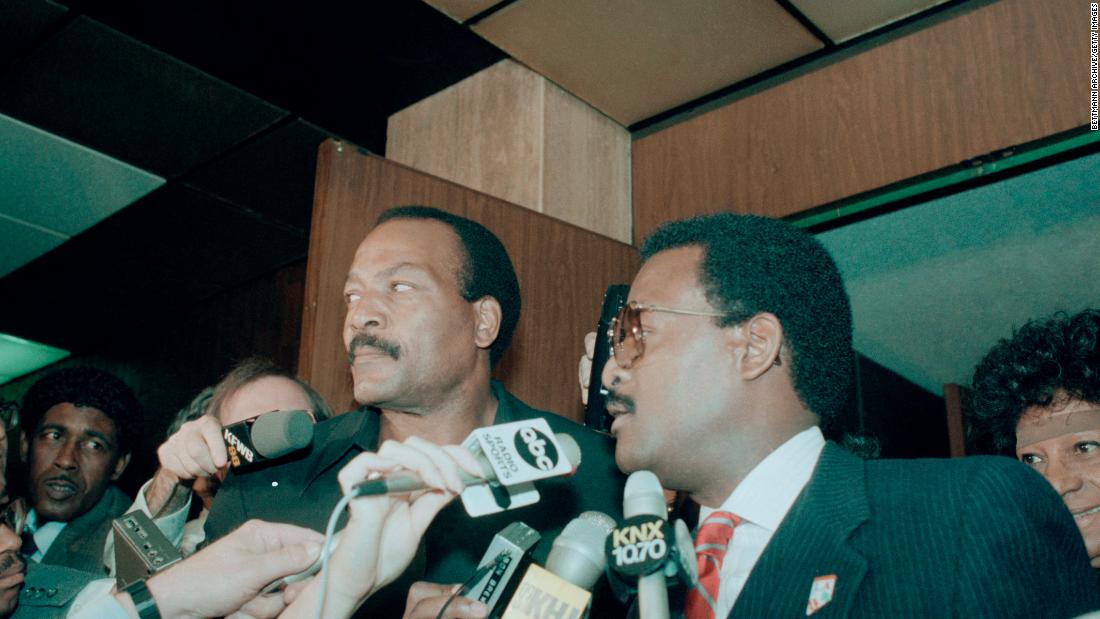 Brown and attorney Johnnie Cochran enter a court in Los Angeles in 1985. That year, Brown was charged with raping and assaulting a 33-year-old woman in his home. The judge later dismissed the charges based on inconsistent testimony. During the 1960s, Brown was charged on two separate occasions with assaulting women: a jury found him not guilty in one case, and the charge was dismissed in the other after the woman refused to name him as her assailant. In 1999, following a domestic disturbance with his wife, Monique, Brown was arrested and charged with making terrorist threats toward her. In the 911 tape, she accused Brown of threatening to kill her, a claim she later recanted. A jury found Brown guilty of vandalism for smashing his wife&#39;s car with a shovel.