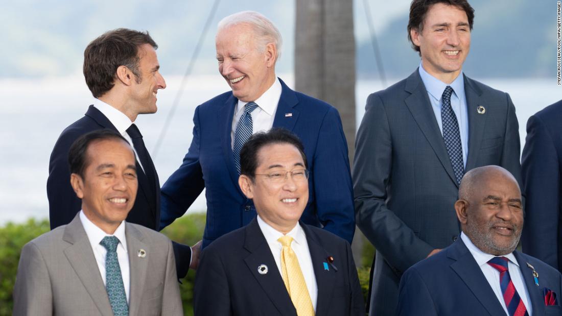French President Emmanuel Macron and US President Joe Biden share a laugh while taking a group picture at the Grand Prince Hotel in Hiroshima during the G7 Summit on Saturday, May 20, in Japan.