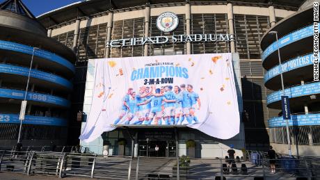 A &quot;Premier League Champions&quot; banner is revealed outside Manchester City&#39;s stadium.