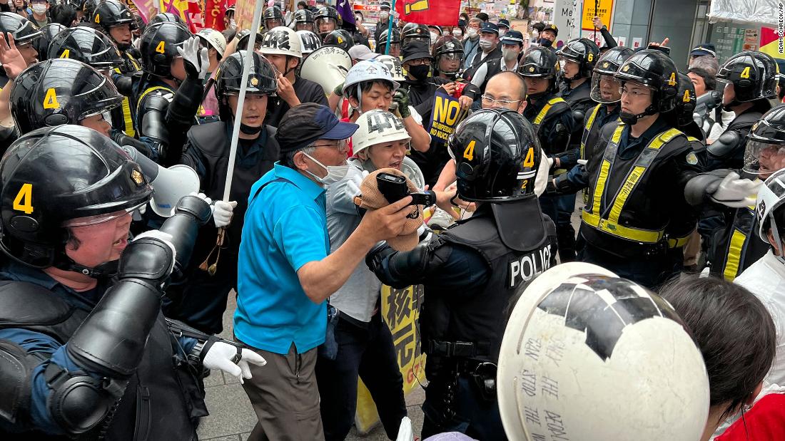 Protesters confront riot police during a march against the G7 meeting on Sunday in Hiroshima.