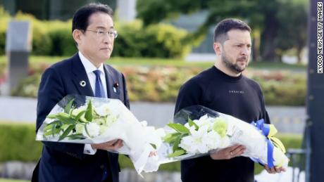 Japanese Prime Minister Fumio Kishida and Ukrainian President Volodymyr Zelensky walk toward the cenotaph for atomic bomb victims at the Peace Memorial Park in Hiroshima on May 21, 2023.