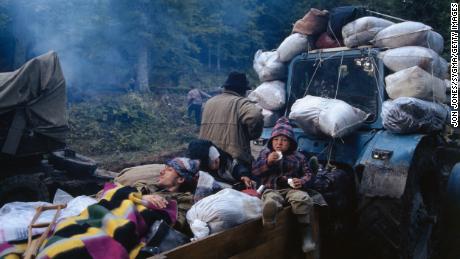 Refugees ride a tractor during the exodus of people after Russia invaded Abkhazia in the early 1990s. Dzvelaia&#39;s family fled at the same time.