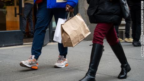 A shopper carries bags in the SoHo neighborhood of New York, US, on Saturday, Jan. 21, 2023. 