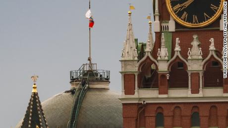 A man works on the roof near the national flag of Russia above the residence of Russian president, at the Kremlin in Moscow, Russia, on May 4. 