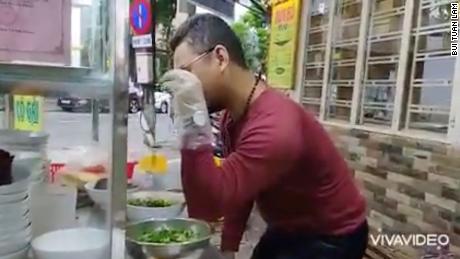 Bui Tuan Lam cooks in Da Nang, Vietnam on November 11, 2021. The noodle vendor and &quot;Salt Bae&quot; impersonator was sentenced to prison on Thursday after being convicted of anti-state propaganda.