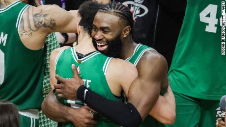 Derrick White #9 and Jaylen Brown #7 of the Boston Celtics react after defeating the Miami Heat 104-103 in game six of the Eastern Conference Finals at Kaseya Center on May 27, 2023 in Miami, Florida. 