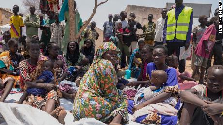 South Sudanese who fled from Sudan sit outside a nutrition clinic at a transit center in Renk, South Sudan, on May 16, 2023. 