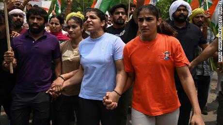 Indian wrestlers Bajrang Punia (L), Vinesh Phogat (2nd L), Sakshi Malik (2nd R) and Sangeeta Phogat (L) attempt to march to India&#39;s new parliament during a protest against Brij Bhushan Singh over allegations of sexual harassment, in New Delhi on May 28, 2023. 