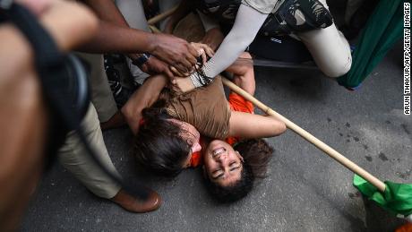Indian wrestlers Sangeeta Phogat and Vinesh Phogat struggle as they are detained by the police while attempting to march to India&#39;s new parliament in New Delhi on May 28, 2023.